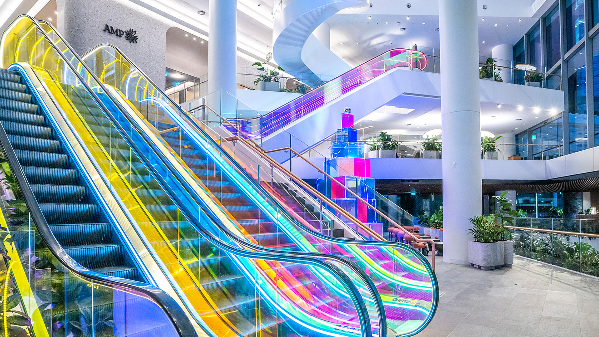 VANDAL Experiential Christmas Campaign for Dexus in the commercial lobby of 50 Bridge Street, Sydney showing dichroic film on escalators and artistic sculpture Christmas tree.