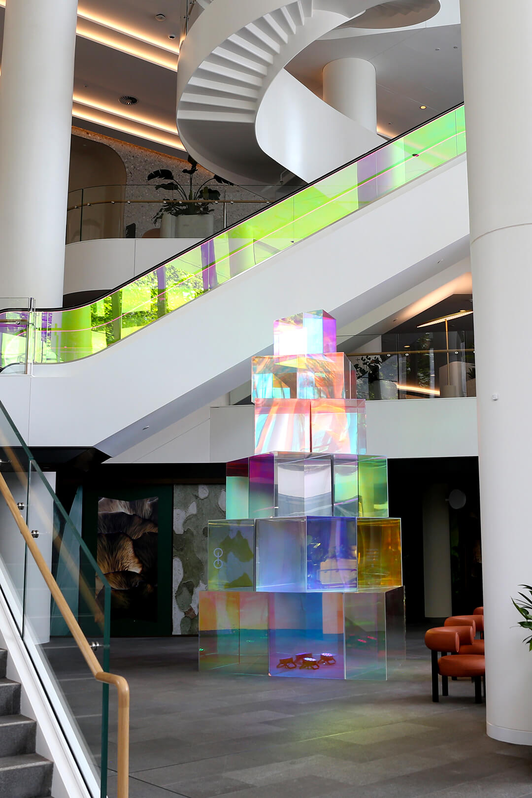 VANDAL Experiential Christmas Campaign for Dexus in the commercial lobby of 50 Bridge Street, Sydney showing dichroic film on escalators and artistic sculpture Christmas tree.