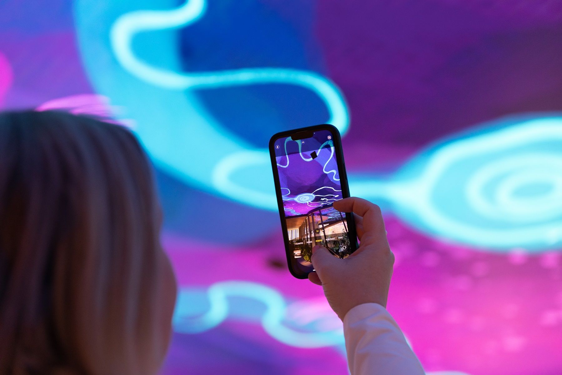 Photo of Mirvac Heritage Lanes commercial lobby foyer in Brisbane Australia showing digital placemaking art screen with vibrant blue indigenous Australian aboriginal artwork created by artist Rachael Sarra in partnership with VANDAL.