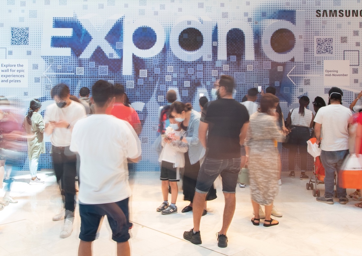 Shoppers interacting with a Sydney based experiential piece for Samsung featuring a mosaic of scannable QR codes that come together to say 'Expand our World'