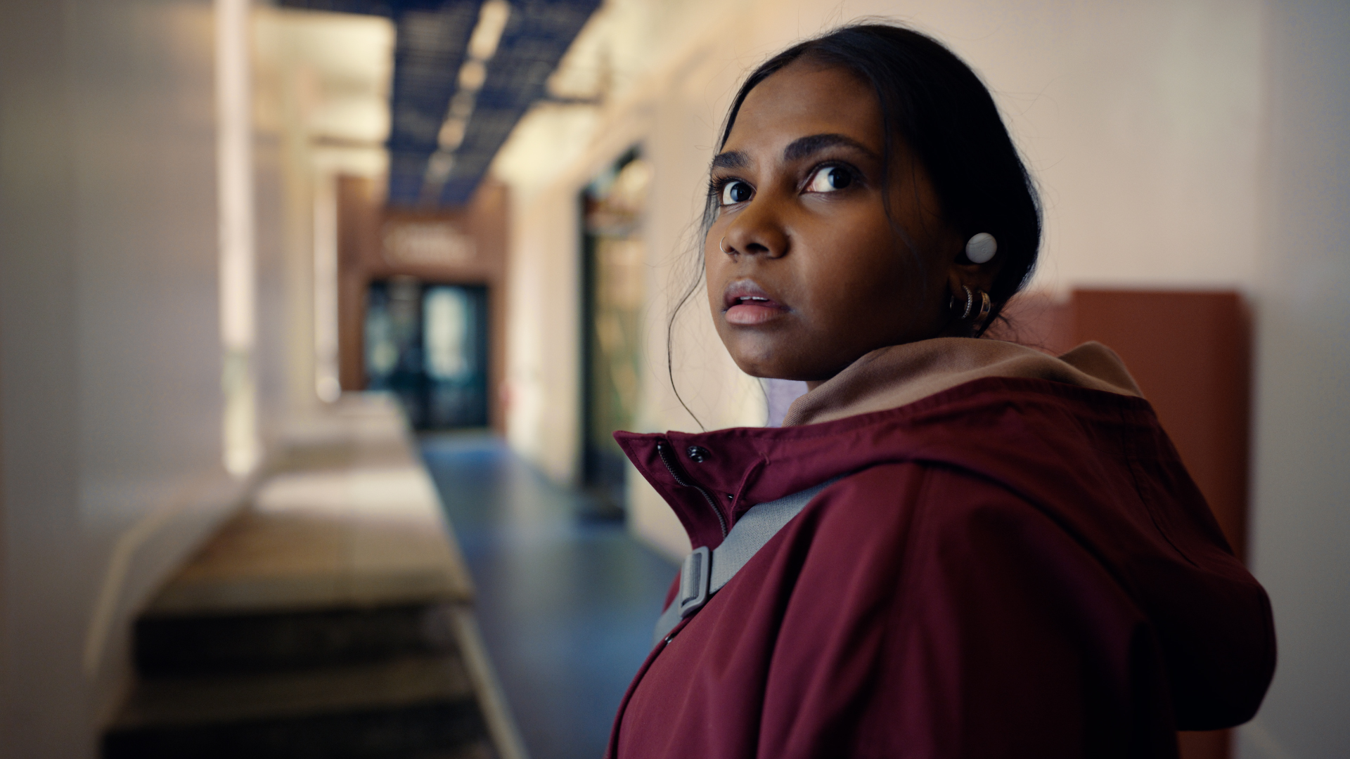 Still from google Helpfulness campaign TVC featuring a young woman in a long hallway