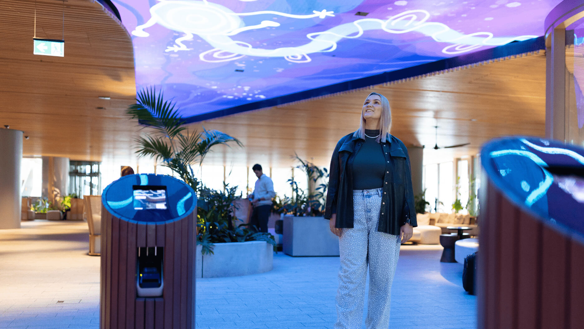 Photo of artist Rachael Sara Mirvac Heritage Lanes commercial lobby foyer in Brisbane Australia showing digital placemaking art screen with vibrant blue indigenous Australian aboriginal artwork created by artist Rachael Sarra in partnership with VANDAL.