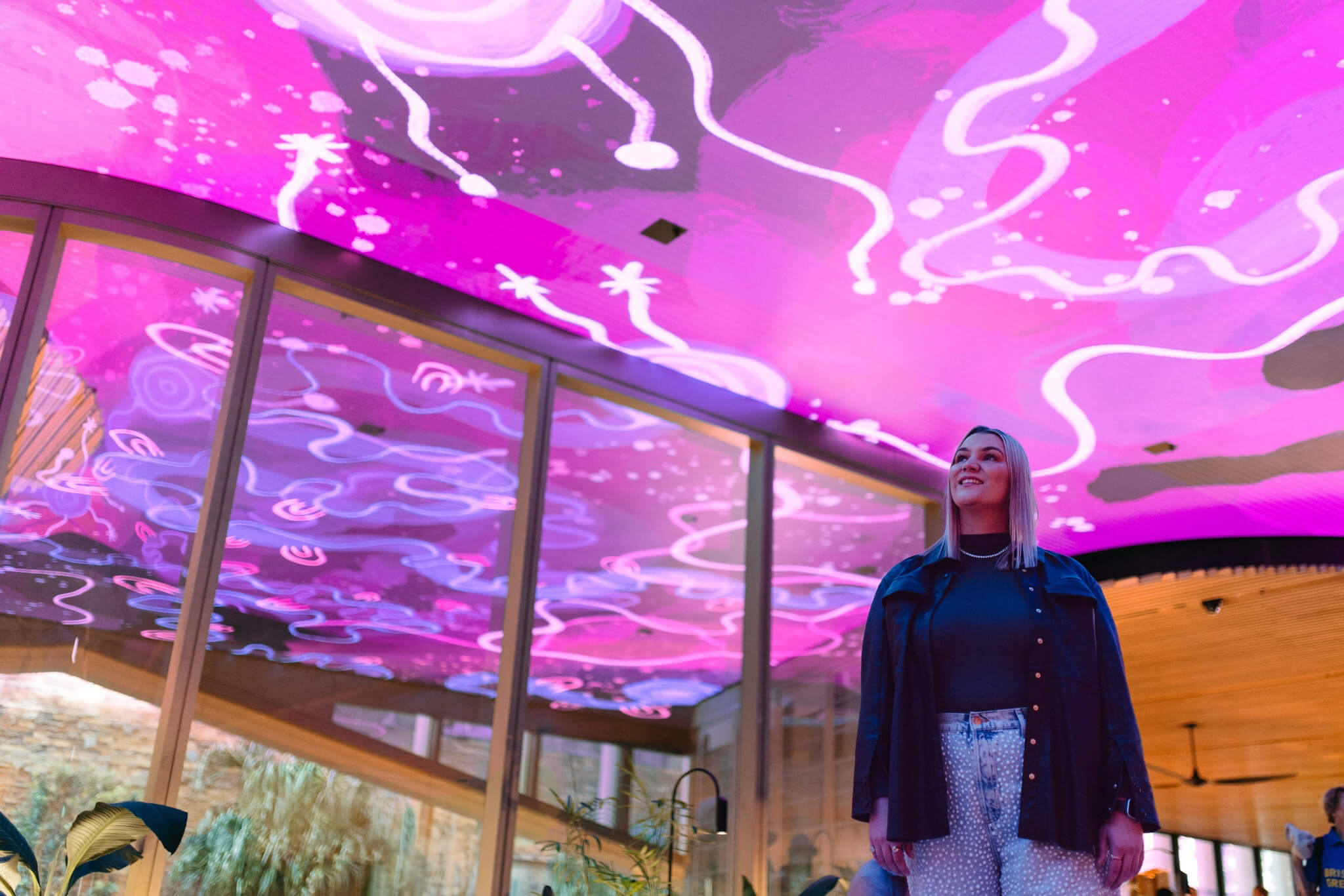 Photo of artist Rachael Sara Mirvac Heritage Lanes commercial lobby foyer in Brisbane Australia showing digital placemaking art screen with vibrant blue indigenous Australian aboriginal artwork created by artist Rachael Sarra in partnership with VANDAL.